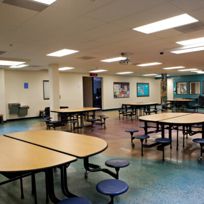 School cafeteria with round tables and colorful floors