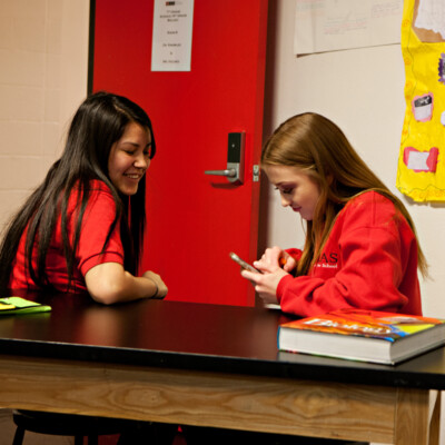 Two female students talking in science class