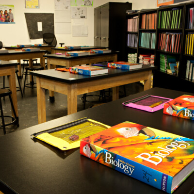 Charter school biology classroom with colorful textbooks at each workstation
