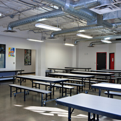 Charter school facility cafeteria filled with sunlight and fold out tables