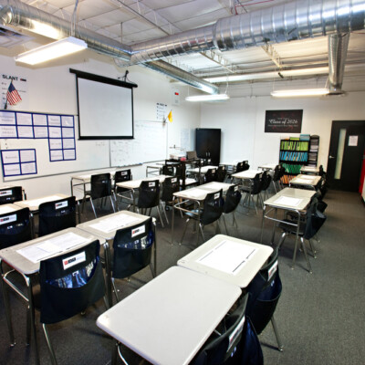 A classroom with lots of desks and chairs in M.A.S. Charter School's facility