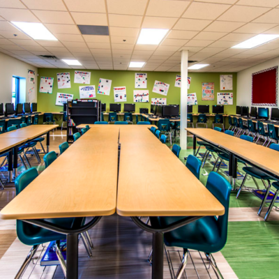 School computer lab with long desks and colorful floors