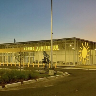 The exterior of the new Young Audiences Charter School building The sun sets over the new young audiences charter school facility