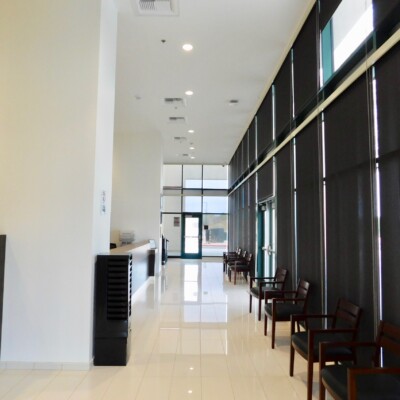 Main lobby for Guidance Charter School, which has white tile floors, white walls and floor to ceiling windows