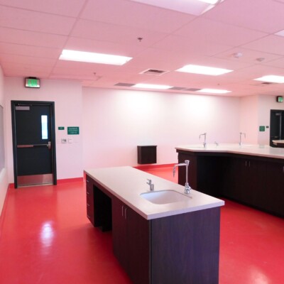 School science lab with red floors, white walls and large work desks