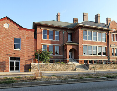 Very large two story red brick charter school facility