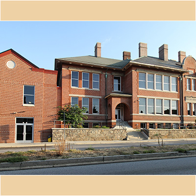 Very large two story red brick charter school facility