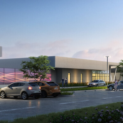 A single story charter school facility with large windows and purple accent wall