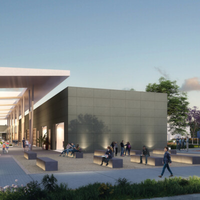 Charter school students walking amid white and gray school buildings surrounded by landscaping