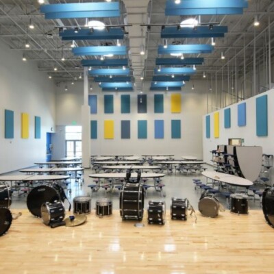 The multipurpose room with wood floors and a high ceiling