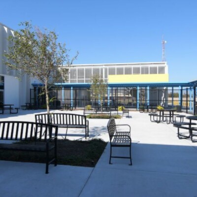Outdoor space for students and staff to enjoy at the new Young Audiences facility An outdoor space with benches at Young Audiences Charter School Facility on a sunny day
